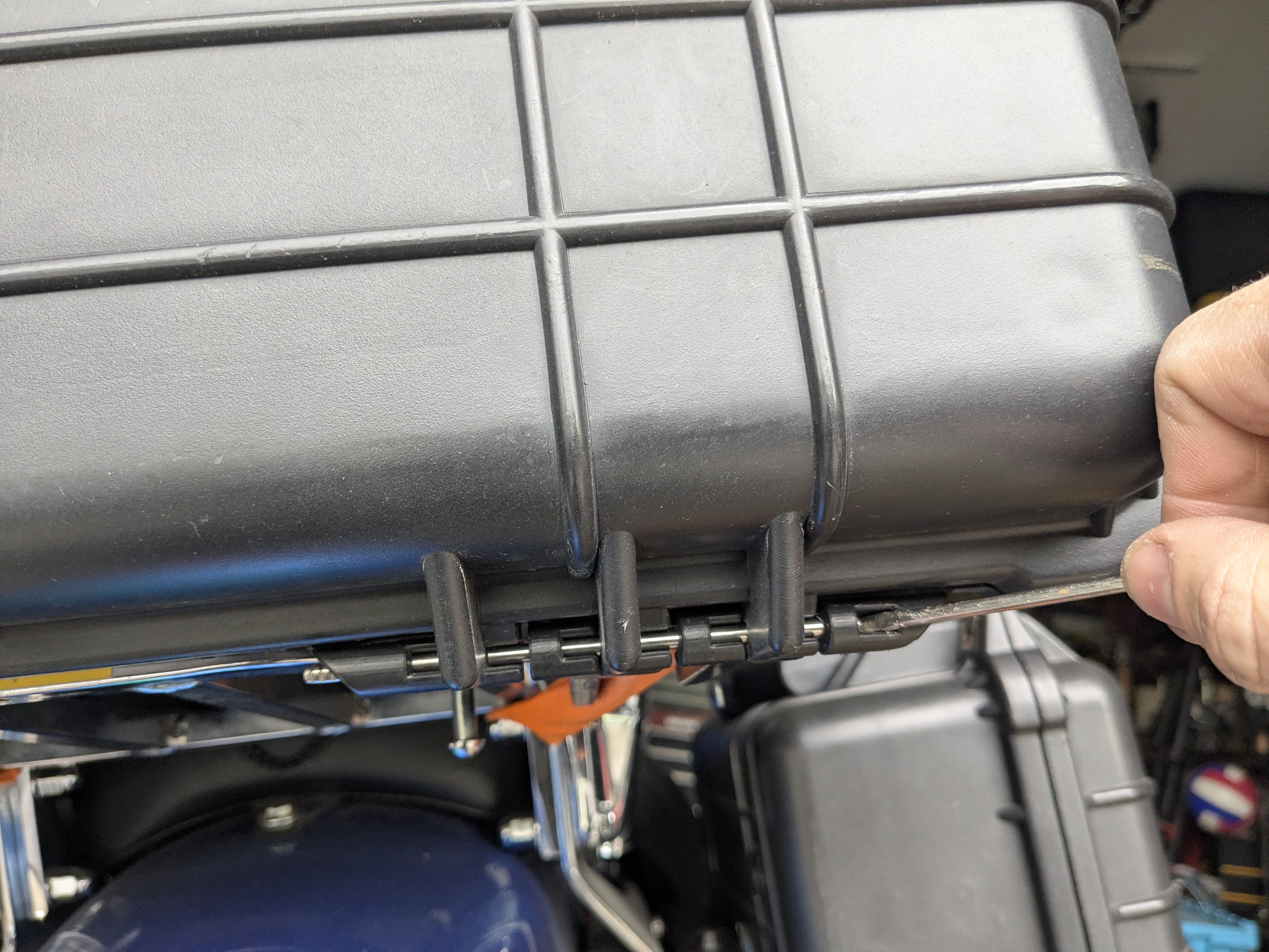Pushing the original hinge pin out far enough to remove it